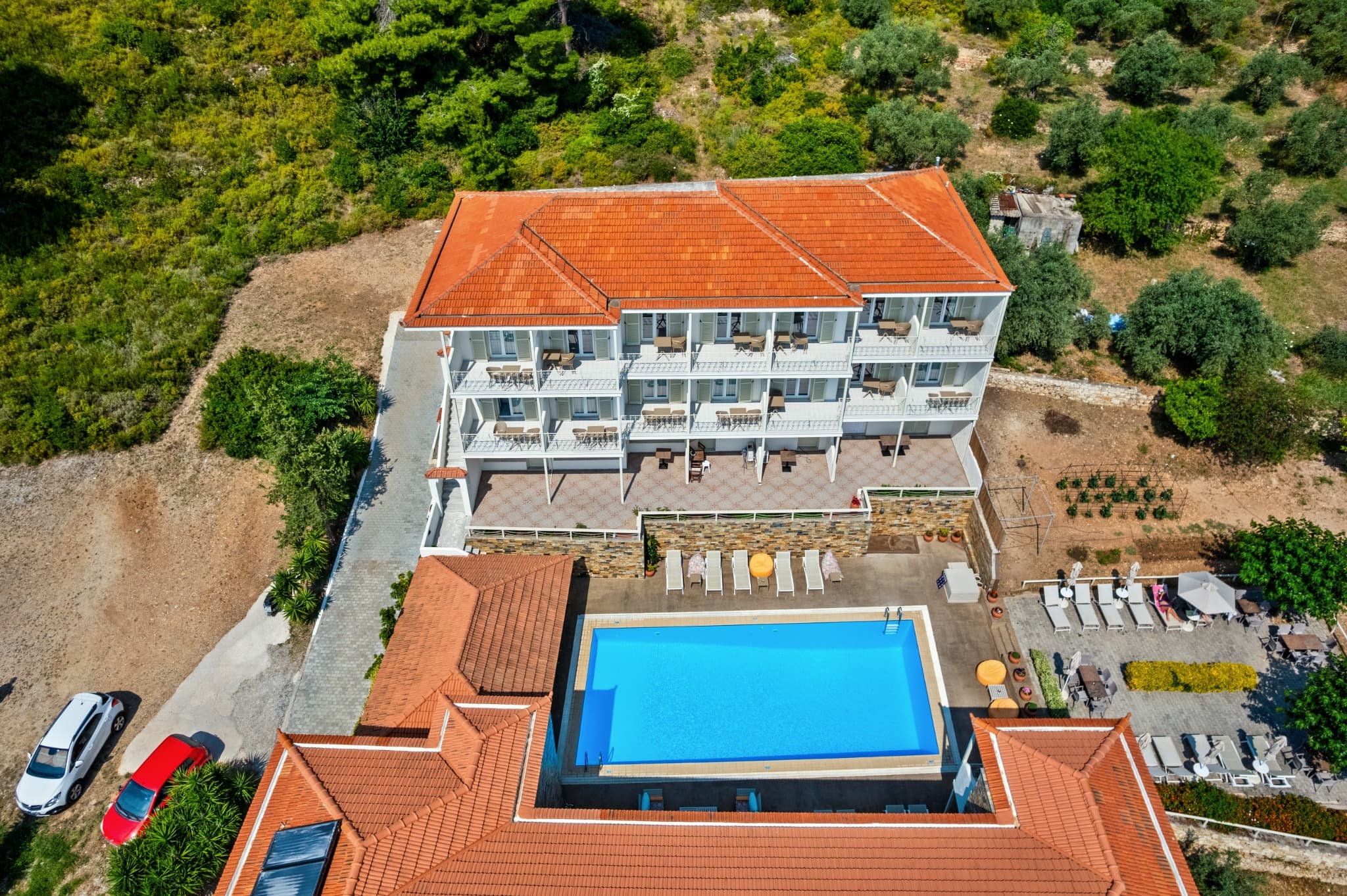 Aerial view of the Nereides pool terrace above Patitiri